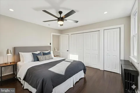a bedroom with a large bed and a chandelier