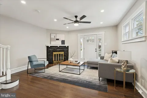a living room with furniture and a wooden floor