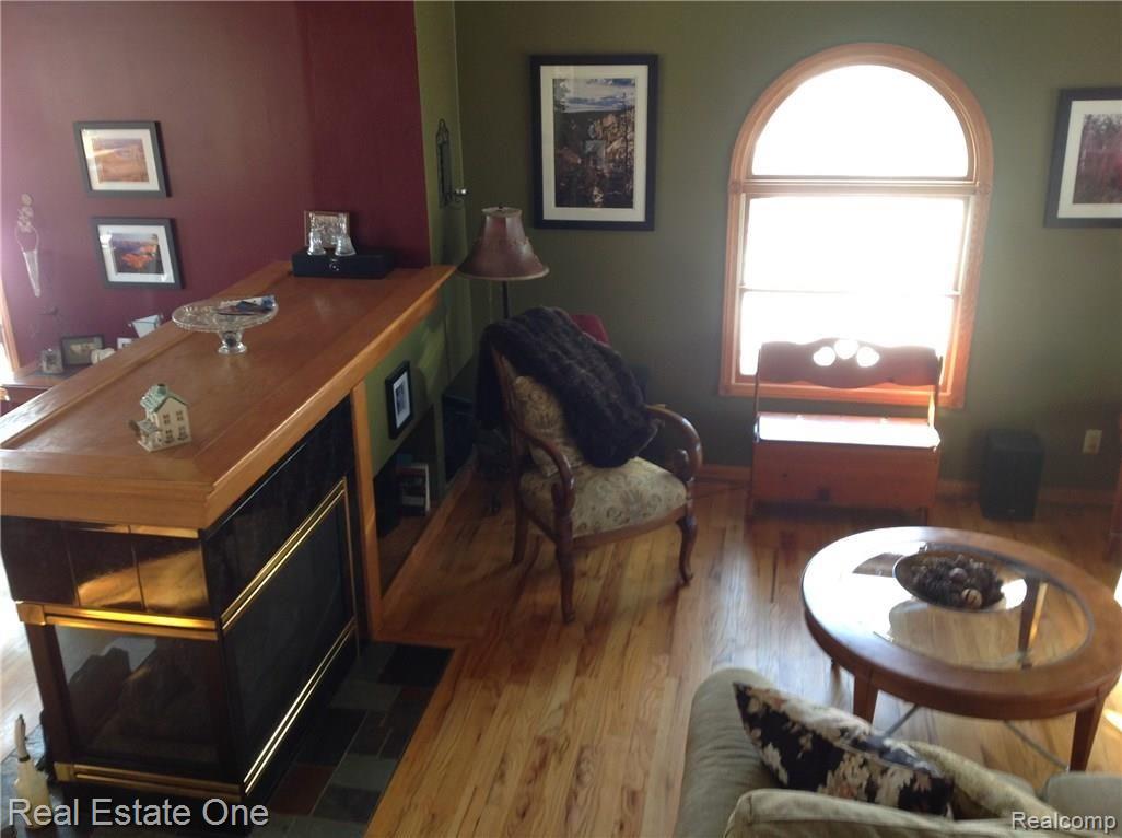 15343 Bird Road Linden, MI 48451 - Photo 9 of 47 3 sided gas fireplace shared with great room and dining room!