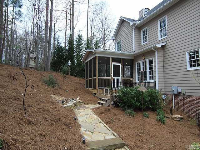 6901 Cresskill Place Raleigh, NC 27615 - Photo 3 of 12 Low maintenance yard with professional landscaping and privacy galore!