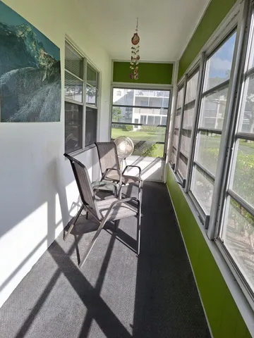 a view of a dining room with furniture wooden floor and a potted plant
