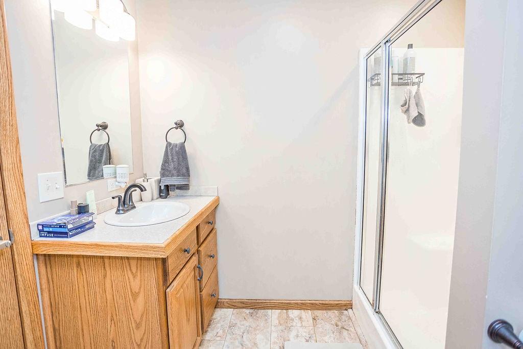 775 Clay Pike Road New Florence, PA 15944 - Photo 30 of 48 a bathroom with a sink a mirror and shower