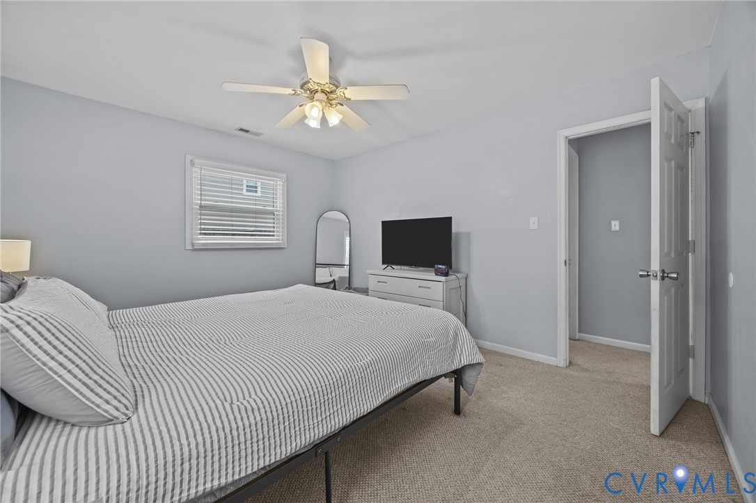 5212 Rollingway Road Chesterfield, VA 23832 - Photo 14 of 25 a bedroom with a bed and a chandelier