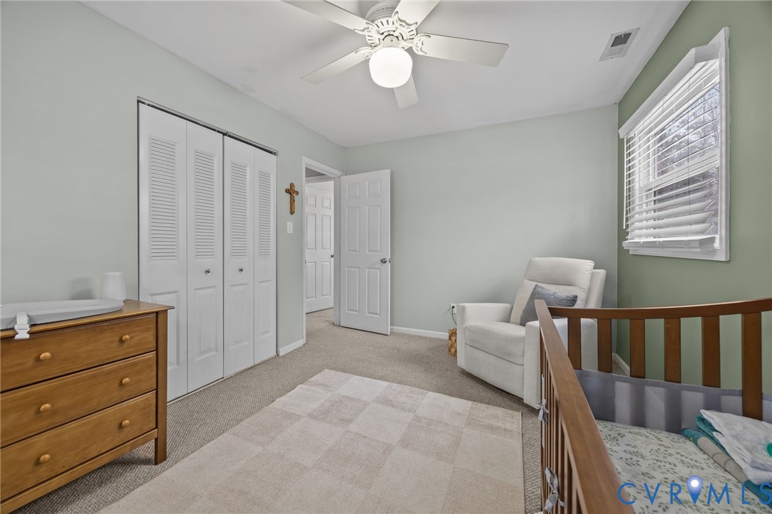 5212 Rollingway Road Chesterfield, VA 23832 - Photo 18 of 25 a spacious bedroom with a bed and a chandelier