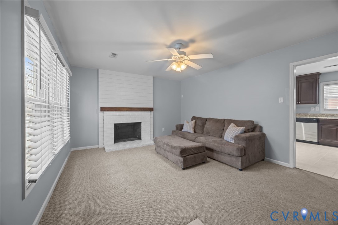 5212 Rollingway Road Chesterfield, VA 23832 - Photo 4 of 25 a living room with furniture a fireplace and a flat screen tv