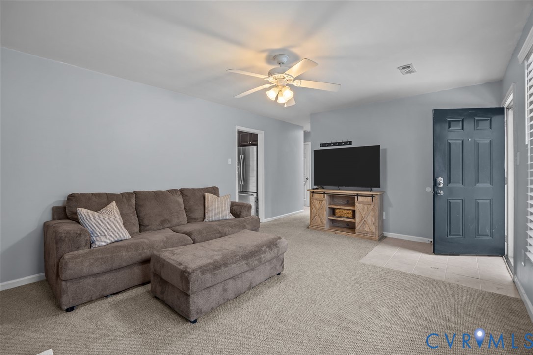 5212 Rollingway Road Chesterfield, VA 23832 - Photo 5 of 25 a living room with furniture a flat screen tv and a ceiling fan