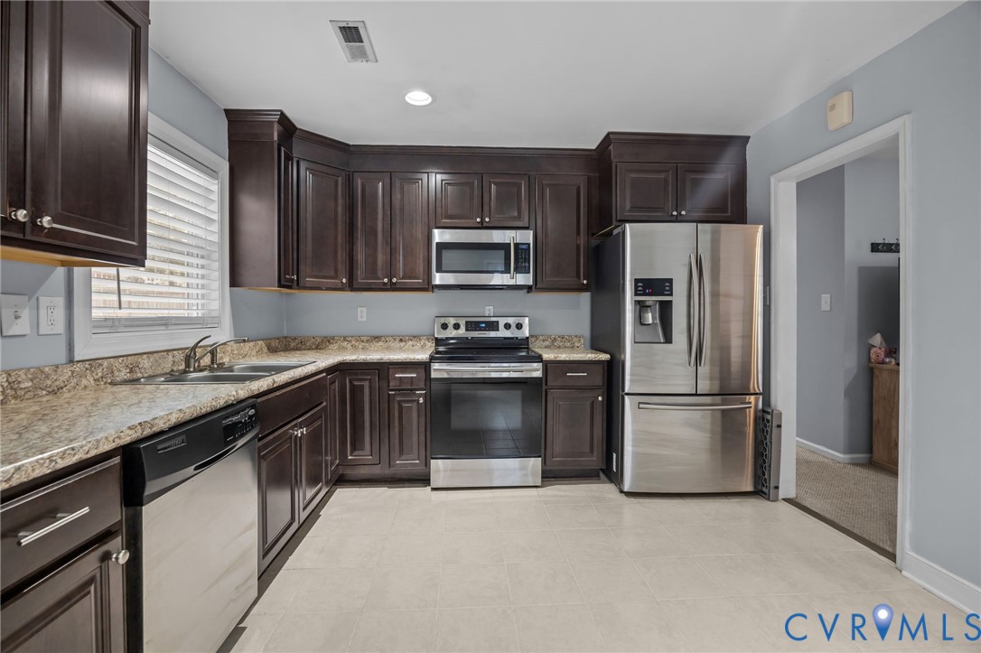 5212 Rollingway Road Chesterfield, VA 23832 - Photo 9 of 25 a kitchen with a refrigerator and a sink