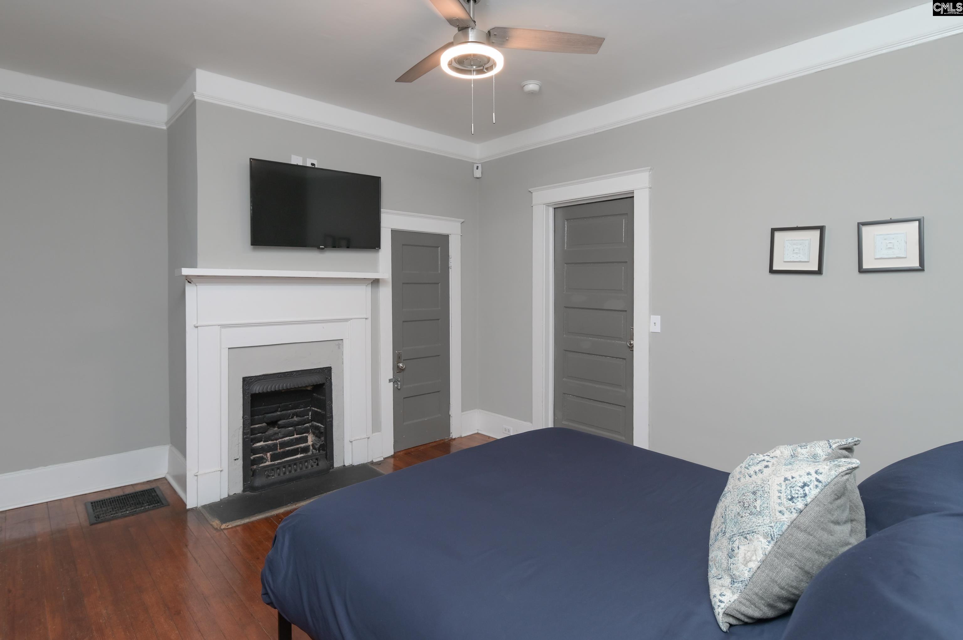 2227 Bull Street Columbia, SC 29201 - Photo 30 of 38 a bedroom with a bed and a fireplace