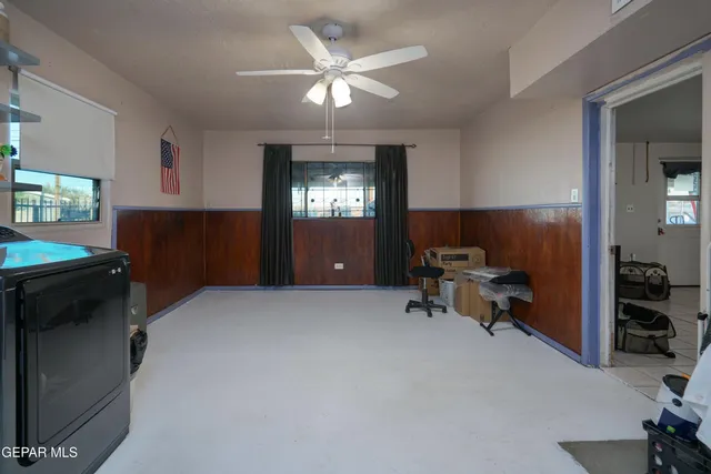 a livingroom with workspace and a window