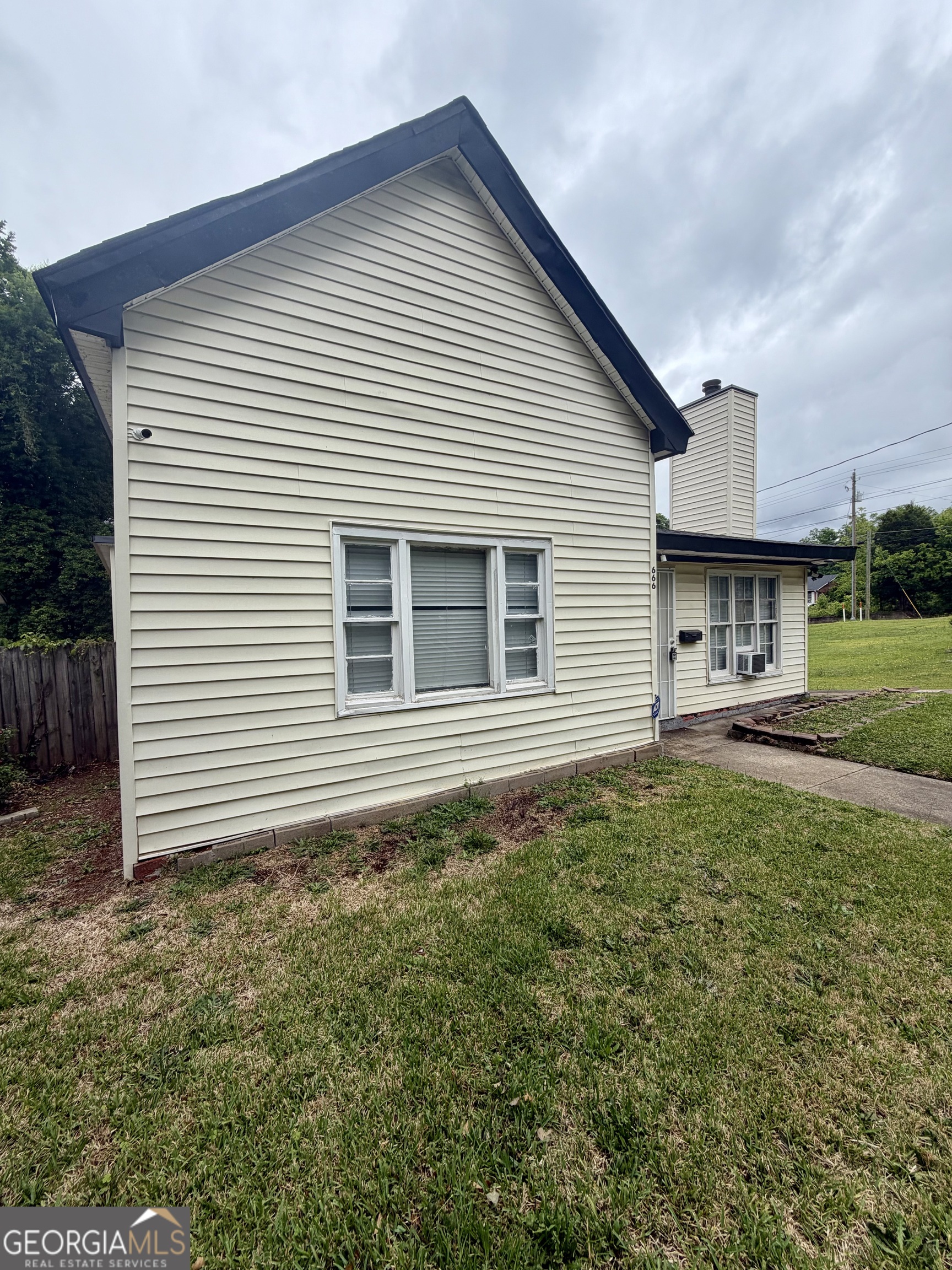 666 Woolfolk Street Macon, GA 31217 - Photo 4 of 60 a view of a house with backyard and garden