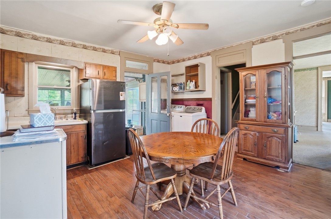 1444 Eagle City Road Springfield, OH 45504 - Photo 21 of 50 This spacious kitchen with wooden floors and essential appliances offers a cozy dining area.