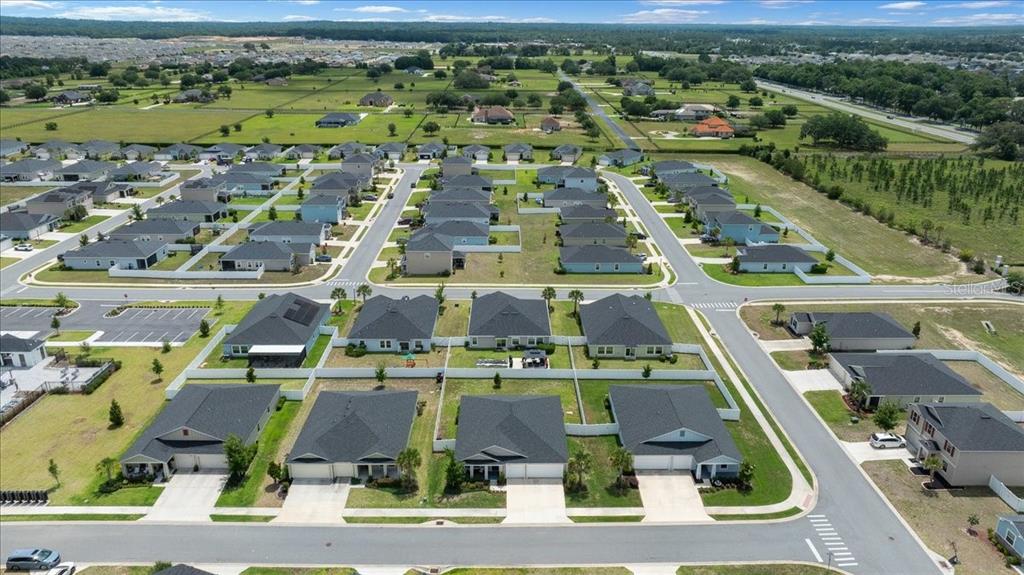 9329 Southwest 57th Terrace Ocala, FL 34476 - Photo 61 of 64 an aerial view of residential houses with outdoor space and parking