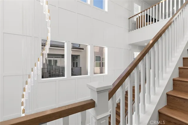 a view of staircase with railing and white walls