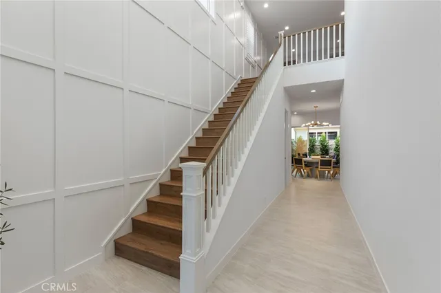 a view of staircase with railing and white walls