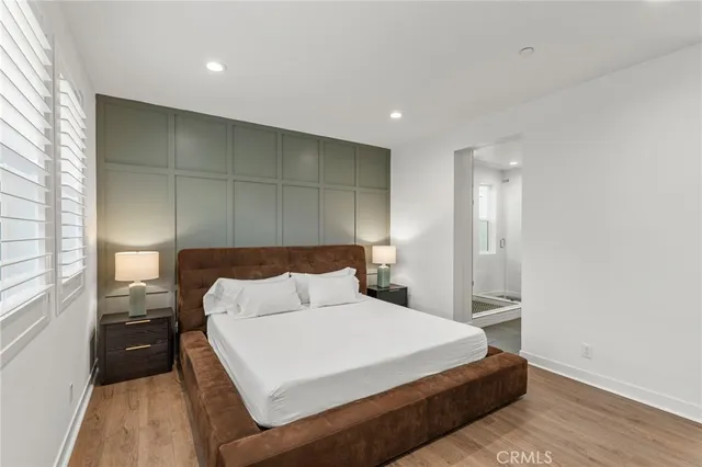 a bedroom with a bed and a large window