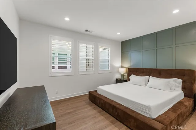 a bedroom with a bed and a large window