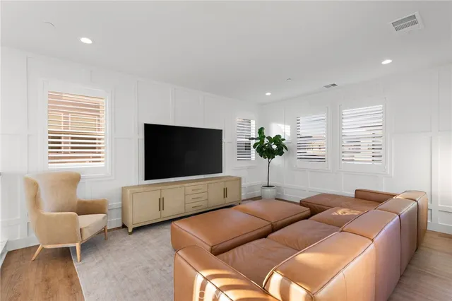 a bedroom with furniture and a flat screen tv