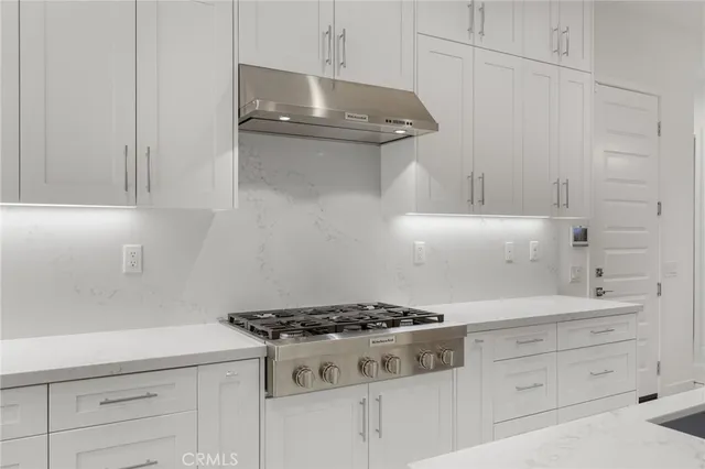a white stove top oven sitting inside of a kitchen