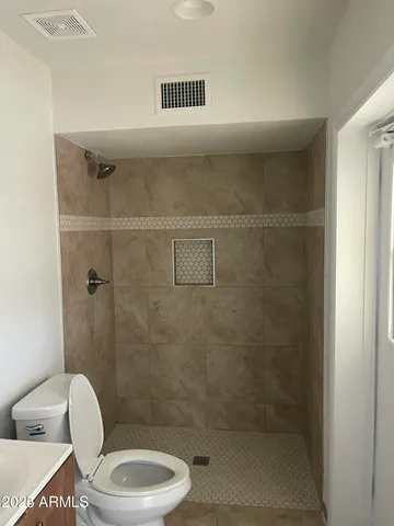 a bathroom with a toilet a sink and shower