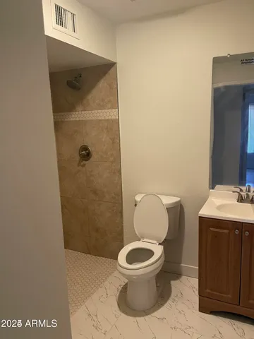 a bathroom with a toilet and a sink