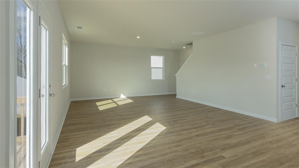 488 Bullock Pass Jefferson, GA 30549 - Photo 12 of 61 a view of a hallway with wooden floor and cabinet