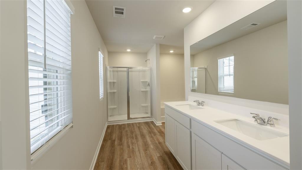 488 Bullock Pass Jefferson, GA 30549 - Photo 23 of 61 a spacious bathroom with a bathtub shower sink vanity and mirror