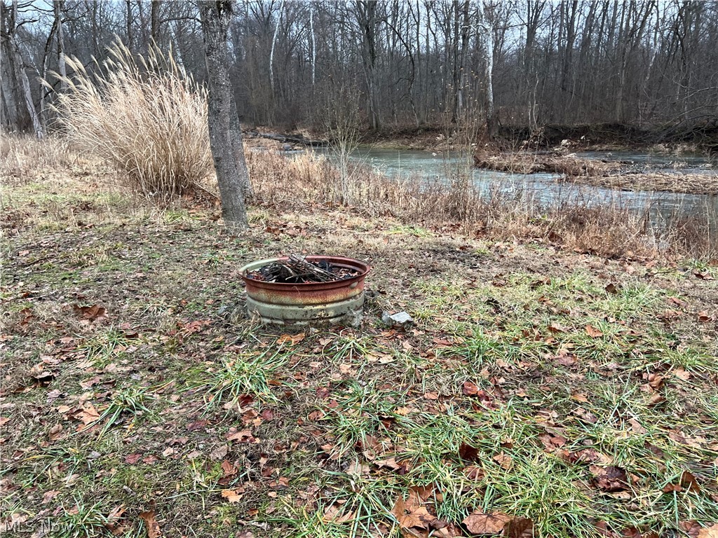4512 Wenz Road Wakeman, OH 44889 - Photo 9 of 19 View of yard featuring a water view and an outdoor fire pit