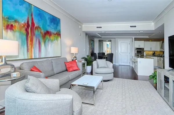 a living room with furniture and painting on the wall