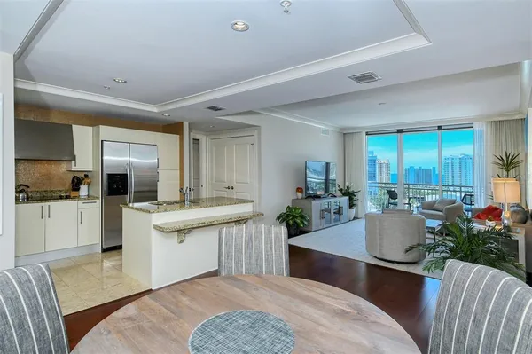 a kitchen with granite countertop a sink a stove and refrigerator