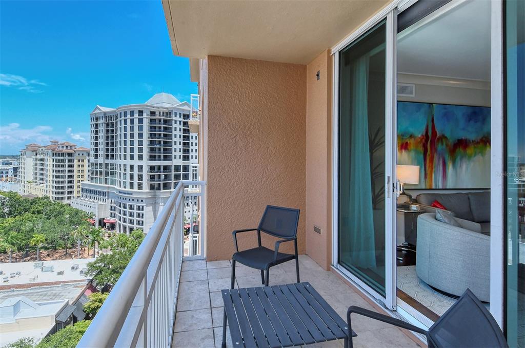 1350 Main Street, Unit 1202 Sarasota, FL 34236 - Photo 2 of 41 a balcony with two chairs and a table