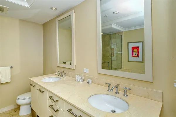 a bathroom with a tub a sink and glass door