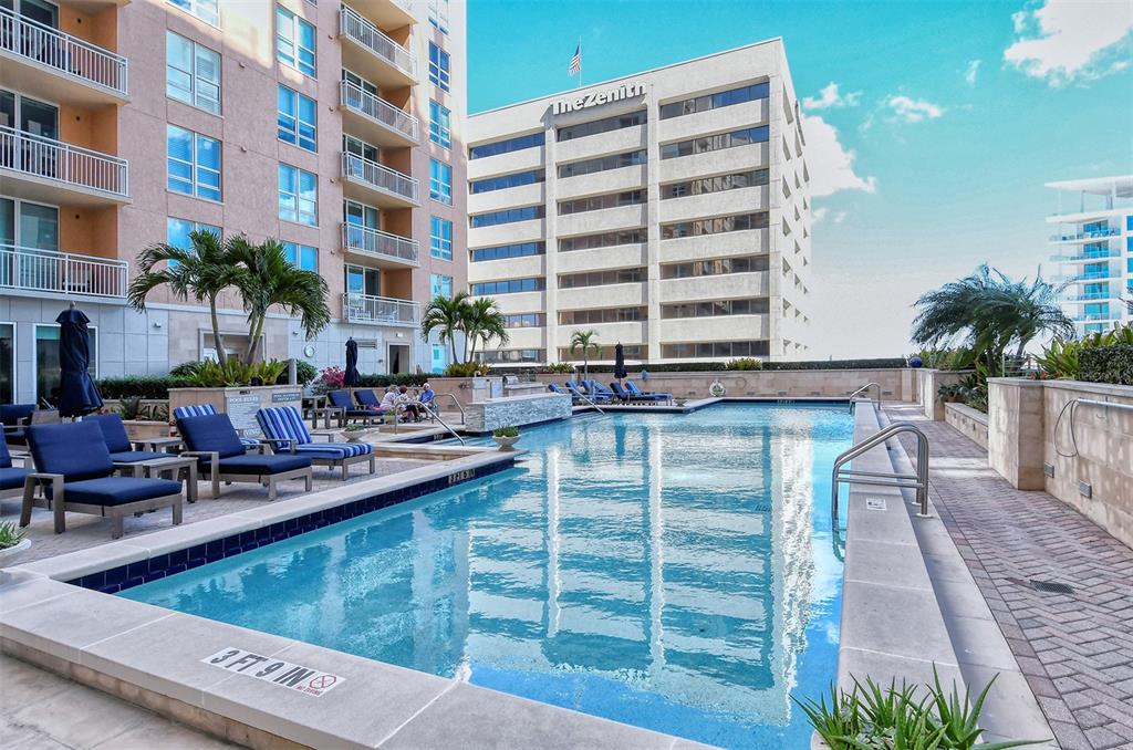 1350 Main Street, Unit 1202 Sarasota, FL 34236 - Photo 24 of 41 a view of a swimming pool with outdoor seating