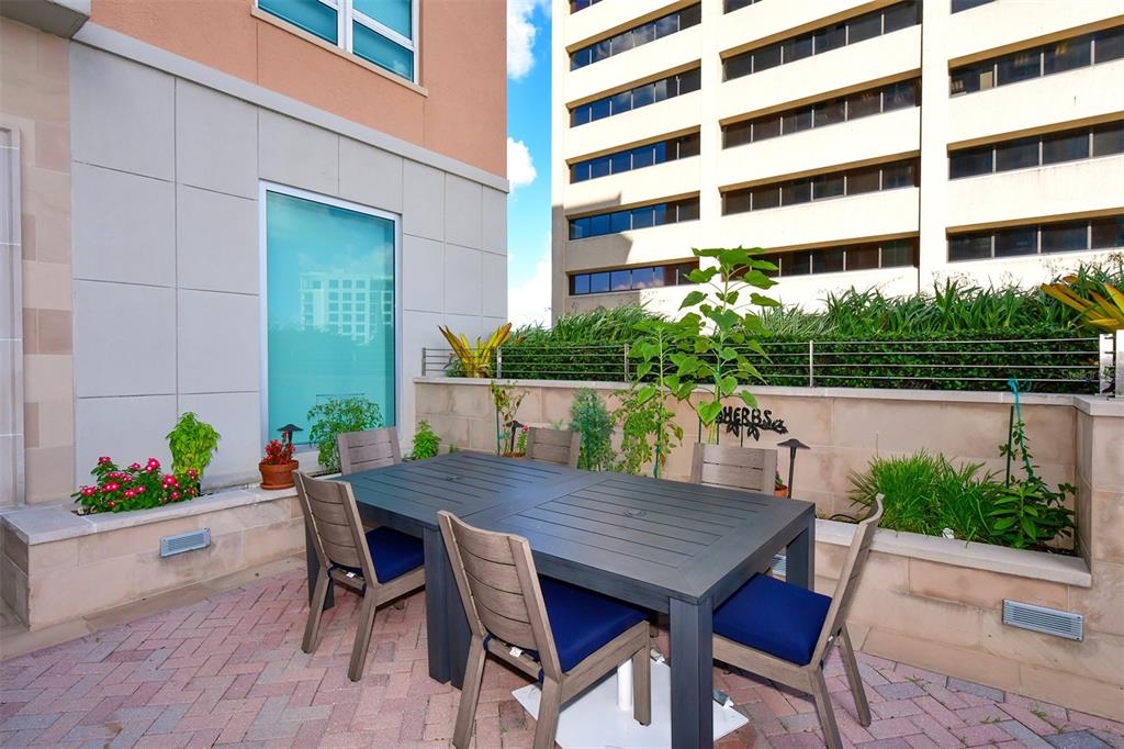 1350 Main Street, Unit 1202 Sarasota, FL 34236 - Photo 33 of 41 a view of a patio with a table and chairs