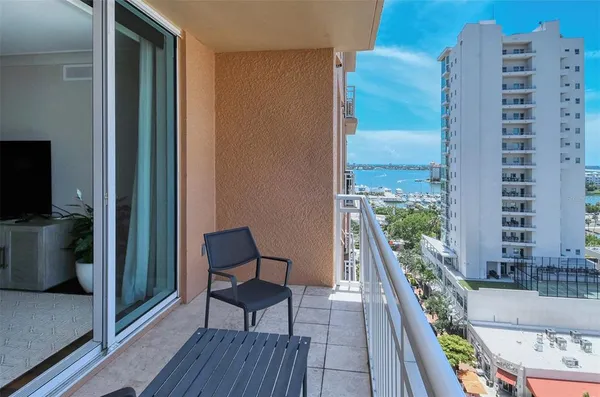 a balcony view with a seating space