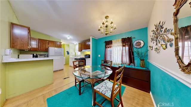 a view of a dining room with furniture and chandelier