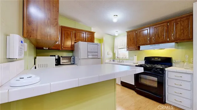 a kitchen with a refrigerator stove and a sink
