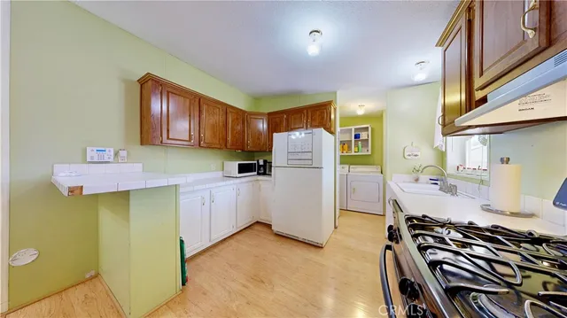 a kitchen with a refrigerator and a stove