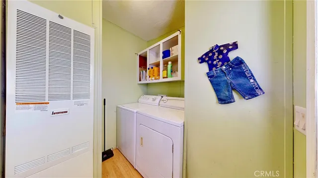 a utility room with a refrigerator and a window
