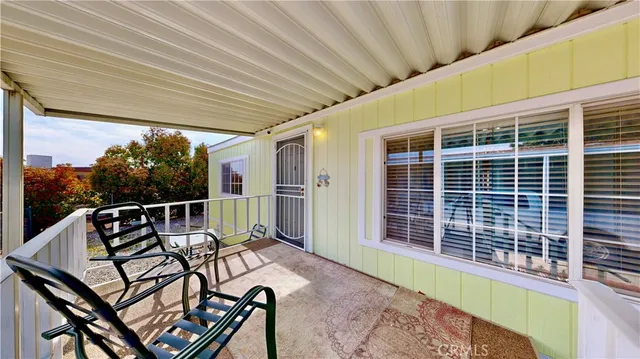 a roof deck with table and chairs and wooden floor