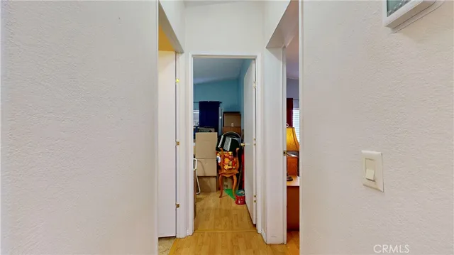 a view of a hallway with wooden floor and entryway