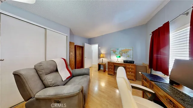 a living room with furniture piano and a window