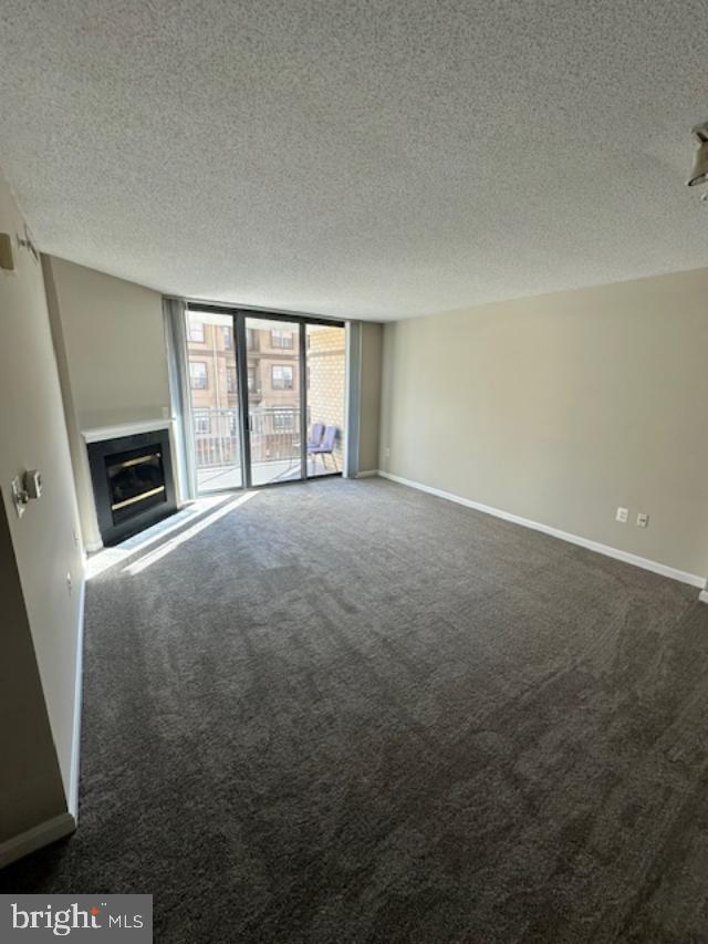 11710 Old Georgetown Road, Unit 212 North Bethesda, MD 20852 - Photo 4 of 23 a view of empty room with window and fireplace