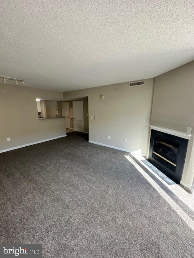 11710 Old Georgetown Road, Unit 212 North Bethesda, MD 20852 - Photo 5 of 23 a view of an empty room with a fireplace and a window