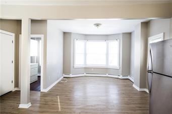 344 Bushkill Street, Unit 2 Easton, PA 18042 - Photo 16 of 30 A generous bay window creates an inviting, well-lit living space with durable wood flooring.