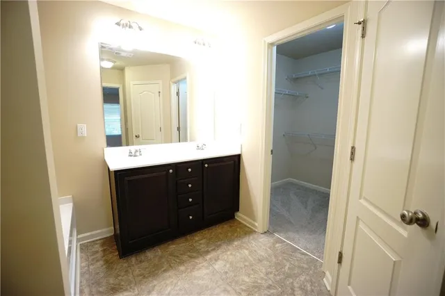a bathroom with a shower and a sink