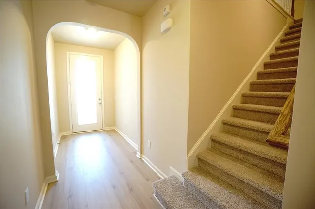 a view of a kitchen with stainless steel appliances granite countertop a refrigerator and a sink