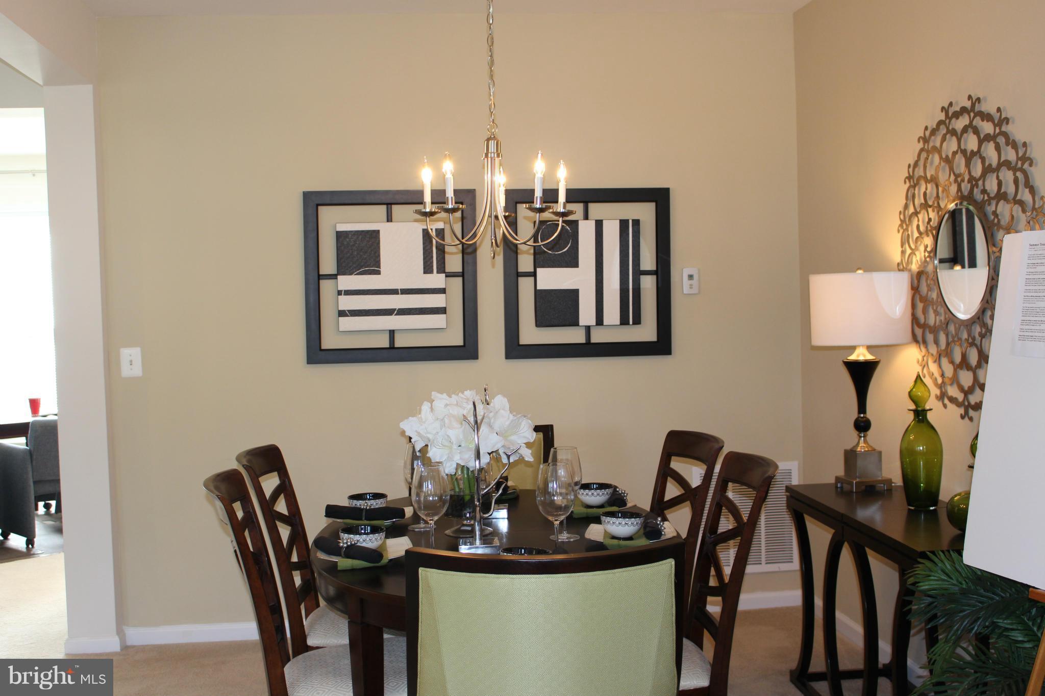 17690 Possum Point Road Dumfries, VA 22026 - Photo 4 of 7 a dining room with furniture and chandelier