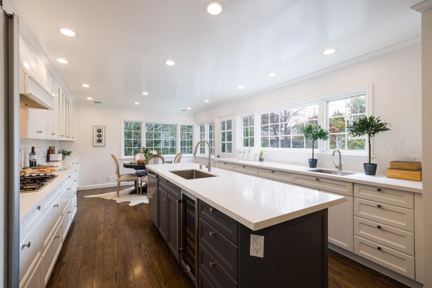 628 Alhambra Road San Mateo, CA 94402 - Photo 11 of 35 a kitchen with sink stove and white cabinets with wooden floor