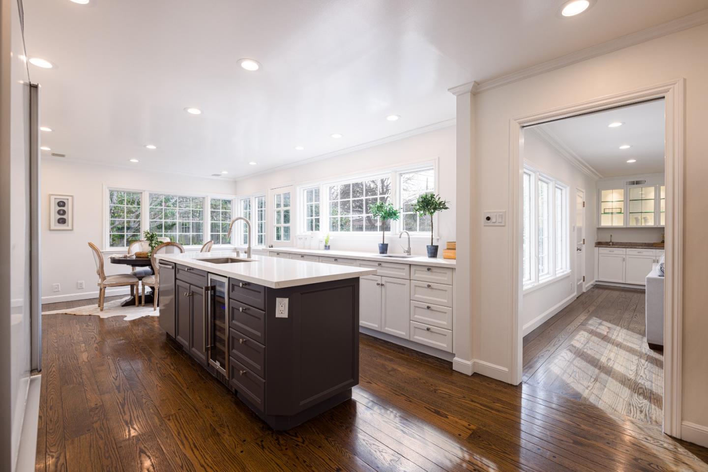 628 Alhambra Road San Mateo, CA 94402 - Photo 14 of 35 a kitchen with kitchen island wooden floors and wooden cabinets