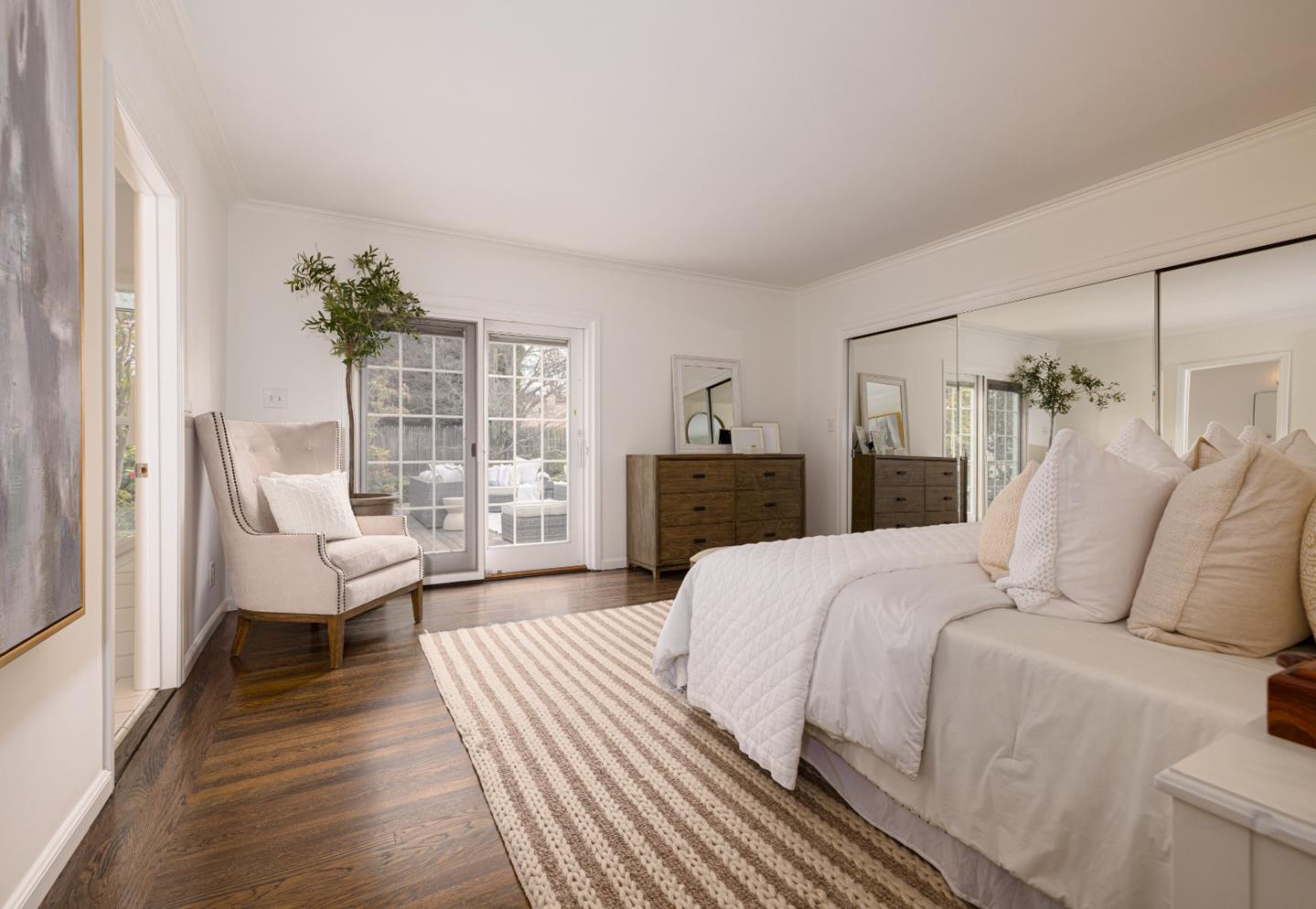 628 Alhambra Road San Mateo, CA 94402 - Photo 20 of 35 a bedroom with a large bed and a wooden floor